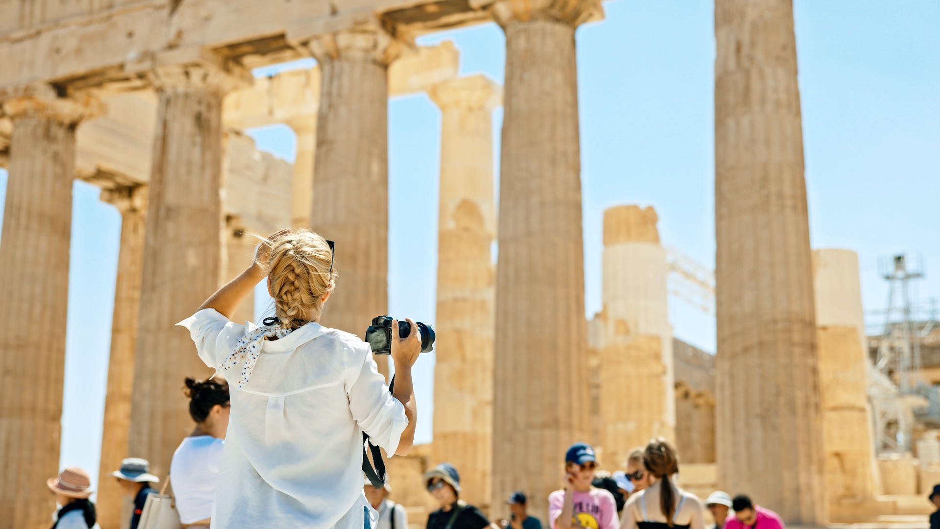 Tourist photographing Parthenon temple using camera during vacation